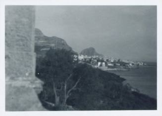 View of ocean and fishing village from the terrace of Villa Maggiacomo, Palermo, dark sky.