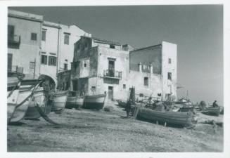 View of grounded fishing boats and apartments