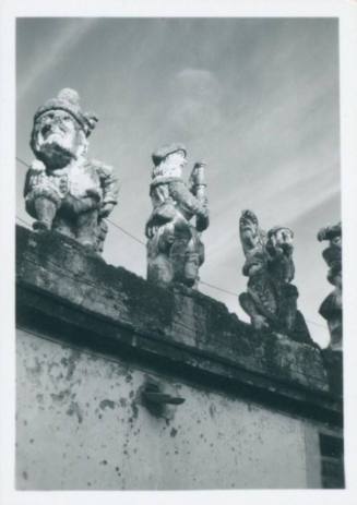 Focus on three statues atop the wall of the Villa Palagonia, Bagheria