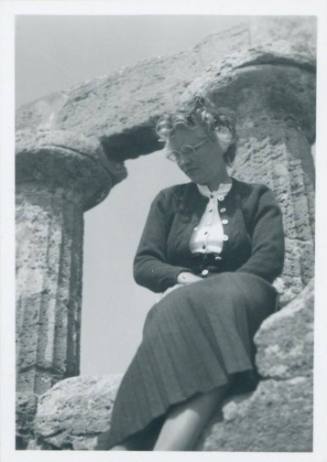 WBG perched on the ruins of Selinunte, with two Doric columns behind her.