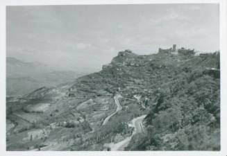 View of hilly Sicilian countryside. On the righthand side a castle/church/other prominent building is visible