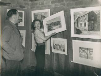 Wilhelmina Barns-Graham and George Downing hanging Cornish Paintings exhibition. [Western Morning News]