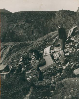 Wilhelmina Barns-Graham and unknown beachcomber at St Ives rubbish dump. Information on reverse. [Central Office of Information]