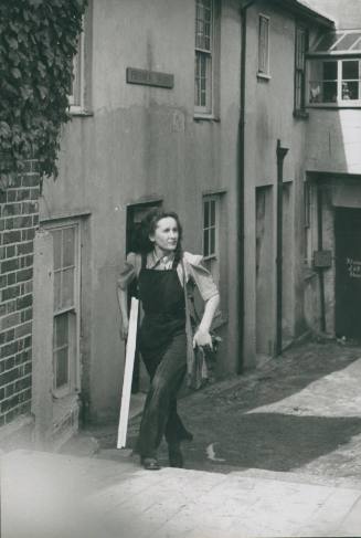 Wilhelmina Barns-Graham carrying framed work outside Porthmeor Studios, St Ives. [Mark Kauffman, Life Magazine].