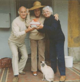 Wilhelmina Barns-Graham, Robert and Pat Adams, holding bowl of crayfish. With Eros at Balmungo front door.