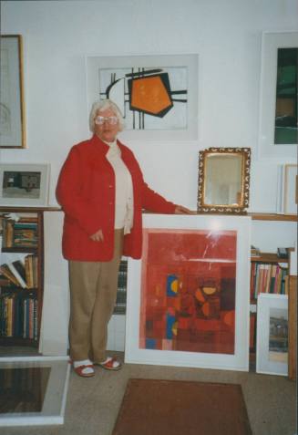 Wilhelmina Barns-Graham standing with painting in Barnaloft.