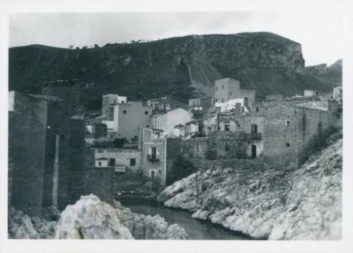 View of St Elia looking in land, with village in foreground and hills in background