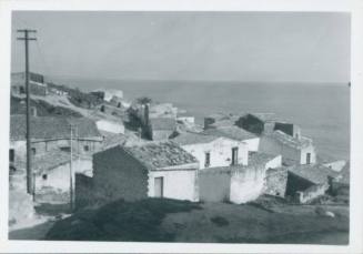 View of coastal village with sea in the background