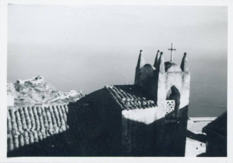 View of roof and small bell tower of the Church of San Giorgio, Castelmola, half in shadow