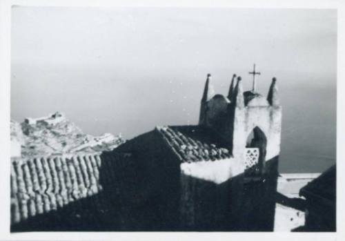 View of roof and small bell tower of the Church of San Giorgio, Castelmola, half in shadow