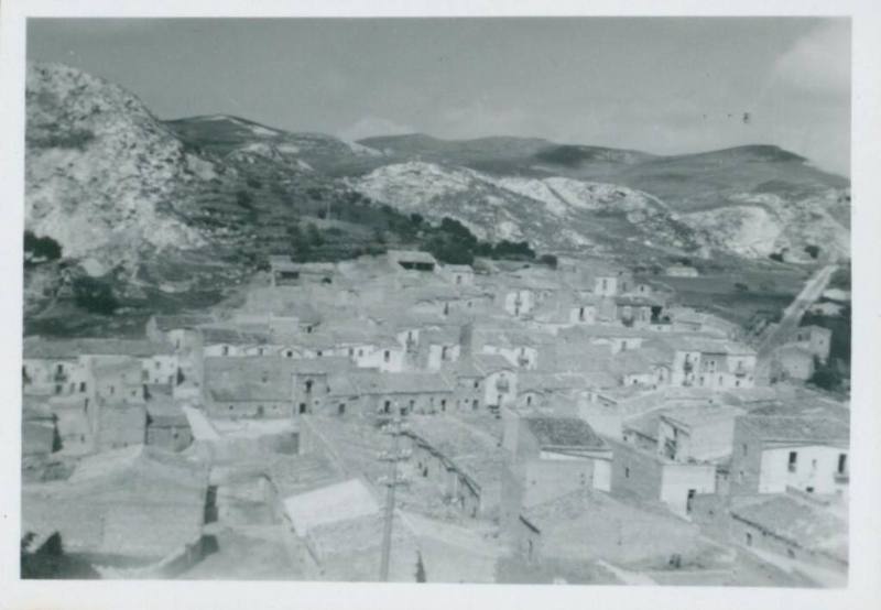 Sicilian town with snowy mountains in background.