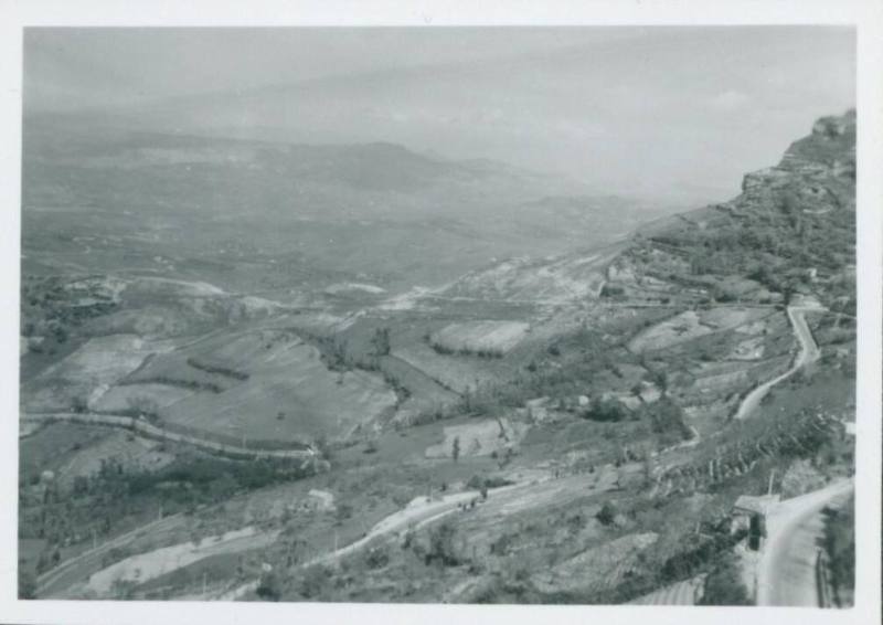 Picturesque shot of Sicilian hilly countryside. Light flurry of snow on ground.