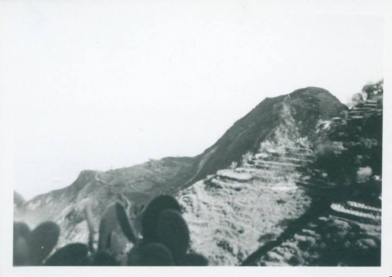 Sicilian hill, with what looks like man made terraces cut into the side of it.