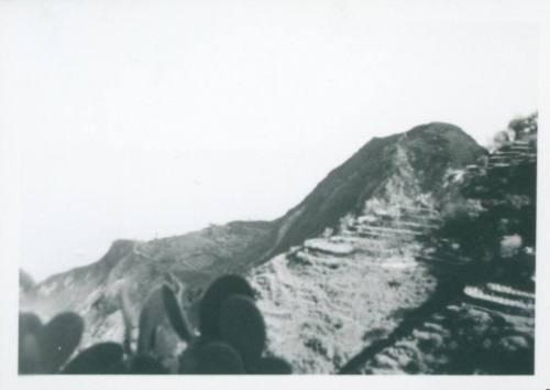 Sicilian hill, with what looks like man made terraces cut into the side of it.