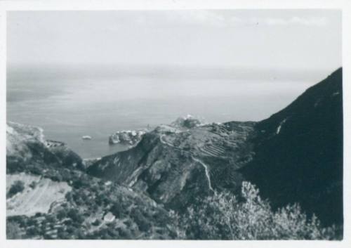 Sicilian hills, with terrace farming visible to the right and the ocean in the background