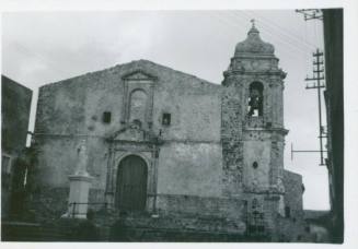 A church with a marble statue to the left of its entrance, and a belltower to its righthand side