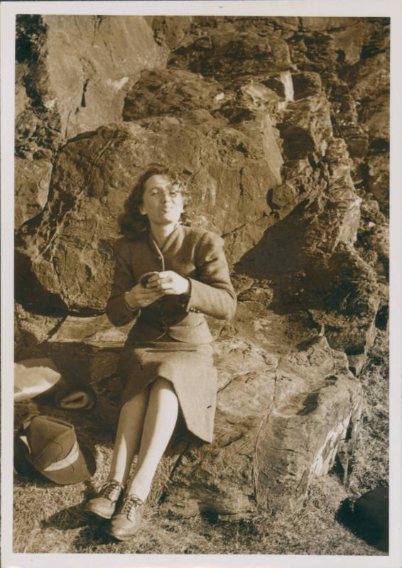 Wilhelmina Barns-Graham sitting on rocks, with compact.