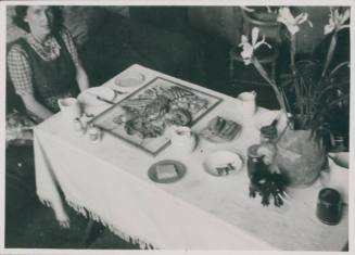 Wilhelmina Barns-Graham sitting at table with lobster dinner. No.3 Porthmeor Studios.