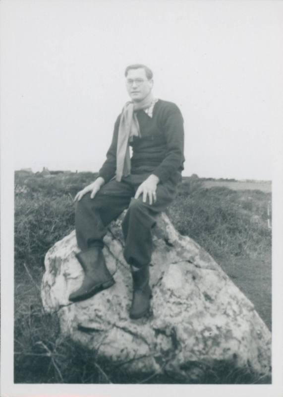 David Lewis sat on rock.