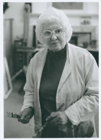 Wilhelmina Barns-Graham holding paintbrushes.